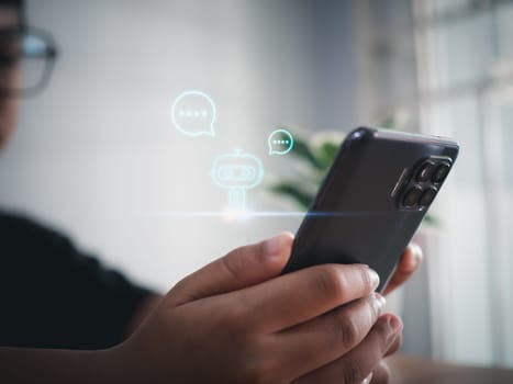 A boy hand uses a smartphone to type live chat, ask, answer with an artificial intelligence system. chat bot. AI.