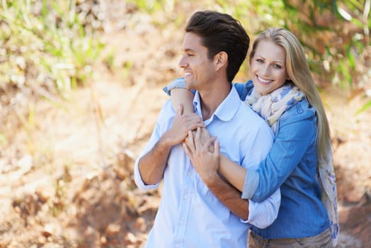 Enjoying a romantic day in nature. A cropped view of a romantic young couple standing together outdoors