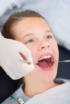 Her day at the dentist. Closeup shot of a young girl having a checkup at the dentist