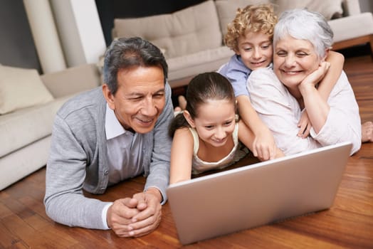 Laptop, floor or grandparents with happy kids for movie streaming online subscription in retirement at home. Children siblings, relax or grandmother watching videos on internet with a senior old man.