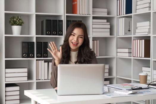 business young woman having video call via laptop in the office.