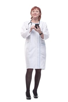 in full growth. medical woman with a smartphone. isolated on a white background.