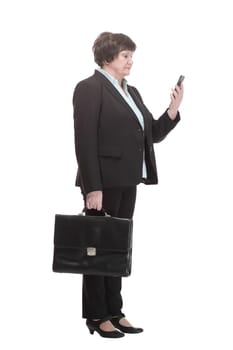 in full growth.Executive business woman with a smartphone. isolated on a white background.