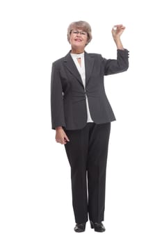 Happy mature woman with key on white background and pointed on them