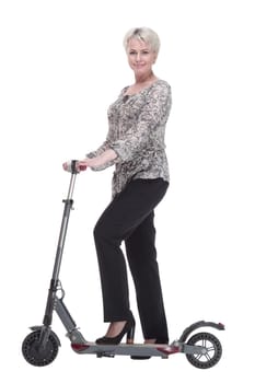 side view. elegant young woman with an electric scooter looking at you . isolated on a white background.