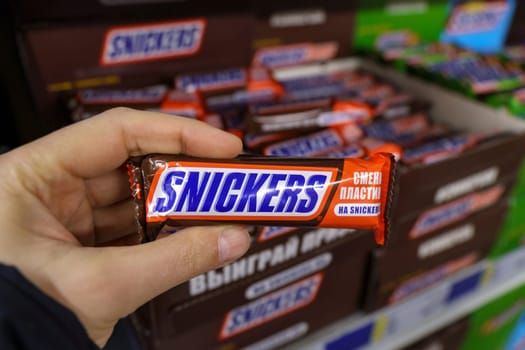 Tyumen, Russia-March 17, 2023: Snickers a well known brand of chocolates from the USA. On supermarket shelves