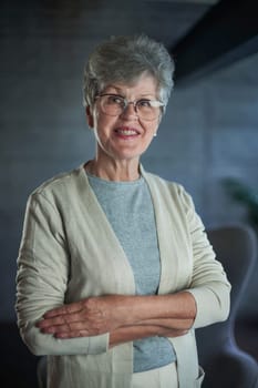 Close up portrait of beautiful senior woman posing at home