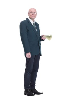 side view. personable business man with a wad of dollar bills. isolated on a white background.