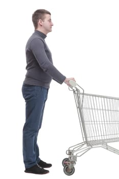 in full growth. casual young man with shopping cart. isolated on a white background.