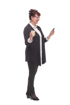 Portrait of thoughtful adult woman wearing eyeglasses holding cellphone and takeaway coffee cup isolated over white background in studio