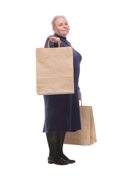 Side view isolated portrait of a senior woman with shopping bags happy smiling and looking at camera