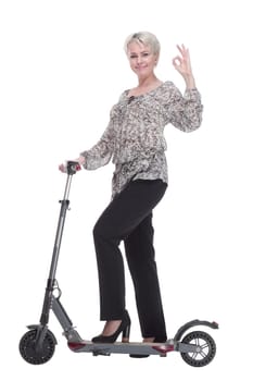 side view. elegant young woman with an electric scooter looking at you . isolated on a white background.