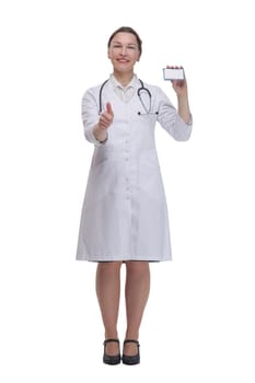 in full growth.medical doctor woman showing her visiting card. isolated on a white background.