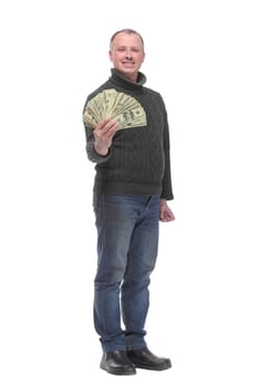 Portrait of smiling young man holding fanned US paper currency isolated over white background