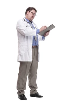 in full growth. qualified doctor with a clipboard.isolated on a white background.