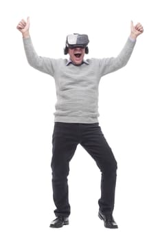 in full growth. smiling man in virtual reality glasses. isolated on a white background.