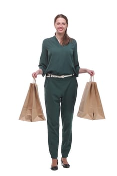 Full length portrait of a young woman walking with shopping bags and smilimg