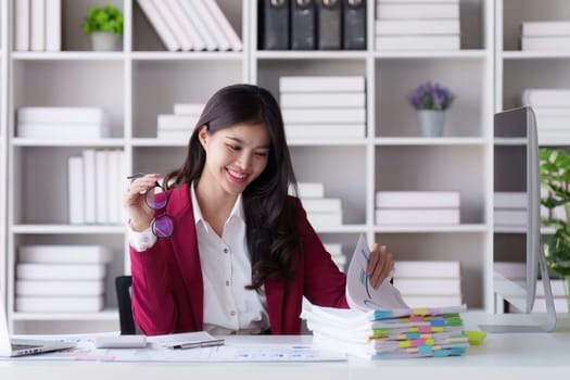 Accountant asian woman working on laptop and do document, tax, exchange, accounting and Financial advisor concept.