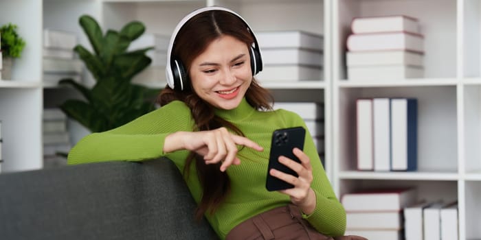 Attractive Asian woman resting comfortable living room and using mobile phone, Relax, Sofa, Lifestyle.