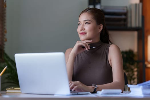 Asian accounting professional calculating household bills, reviewing and analyzing household bills, and filing tax returns..