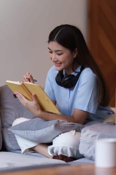 Attractive Asian woman resting comfortable living room and reading book, Relax, Sofa, Lifestyle.