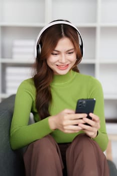 Attractive Asian woman resting comfortable living room and using mobile phone, Relax, Sofa, Lifestyle.