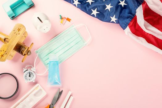 Back to school or college concept. Top view of school supplies stationery, American flag and surgical face mask, isolated on pink background, Back to education new normal during outbreak coronavirus