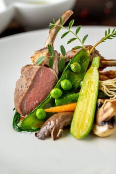 lamb chops with various vegetables at a fine dining restaurant