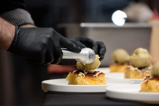 Chief preparing portokalopita, greek orange cake made with shredded filo, greek yoghurt, and olive oil with vanilla ice cream. Mediterranean cuisine dessert.