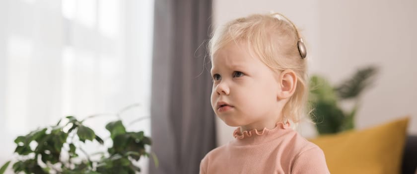 Deaf kid with hearing aid cochlear implant - Hear aid and medicine innovating technology and diversity