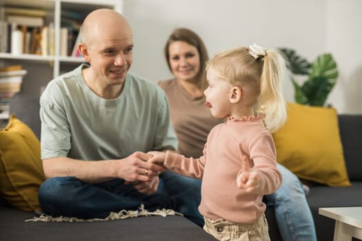 Deaf kid with hearing aid cochlear implant have fun with parents - Hear aid and medicine innovating technology and diversity