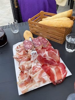 pork curated meat salami and ham delicatessen for happy hour at bistro in Italy
