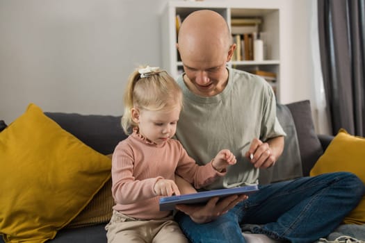 Deaf child girl with cochlear implant studying to hear sounds - recovery after cochlear Implant surgery and rehabilitation