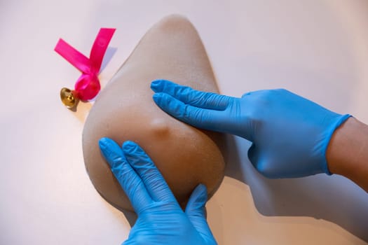 Instructional finger placement techniques during breast examination on the phantom of Lady M. Professional demonstration of breast compression technique during examination.