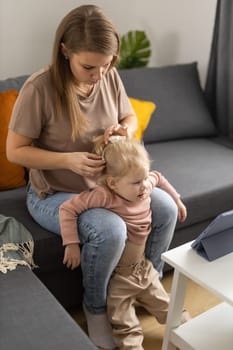 Funny baby with cochlear implant sitting at home and eating. Hear aid and medicine innovating technology and diversity concept