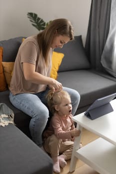 Funny baby with cochlear implant sitting at home and eating. Hear aid and medicine innovating technology and diversity concept