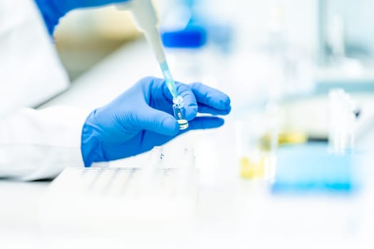 pipetting of chemical samples during research in a biochemical scientific laboratory. High quality photo