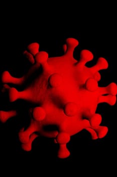 Red coronavirus on a black background close up