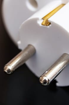 Tee outlet plug on a black wooden table