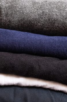 Stack of clothes on a wooden background close up
