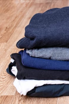 Stack of clothes on a wooden background close up