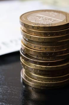 One hundred euro bills and coins close up