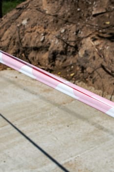 Fence red tape at the construction site close up