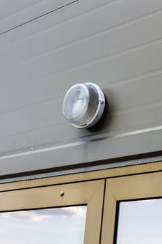 Lamp above the front door on the facade of the building