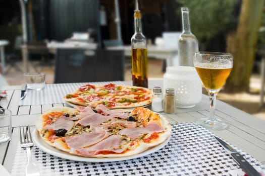 Pizza with ham and chorizo in Italian restaurant