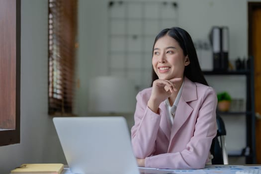 Excited businesswoman using computer laptop while in office, business concepts