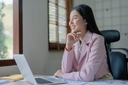 Excited businesswoman using computer laptop while in office, business concepts