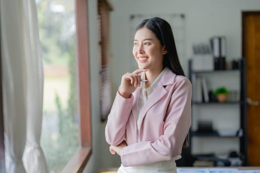 Excited businesswoman using computer laptop while in office, business concepts