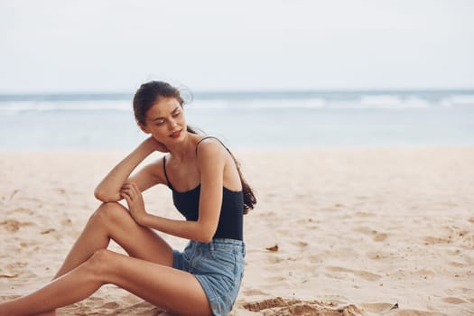 vacation woman beach person summer sand sea ocean freedom young sitting tropical happy smile white nature natural holiday sun attractive travel