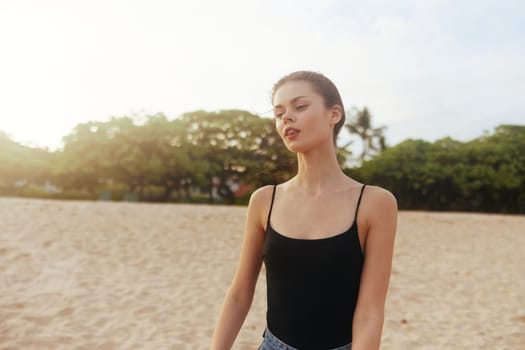 copy woman sand vacation summer lifestyle carefree sea long smile smiling tropical travel nature space jean beach freedom walking free ocean hair sunset